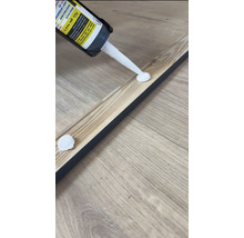 Auftragen von Montagekleber auf eine Holzleiste