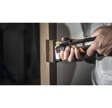 Ein Mann benutzt einen Multifunktionsschleifer von Worx für Holzarbeiten.