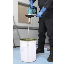 Handwerker mischt Material mit einem Farbmischer von Makita in einem Eimer.