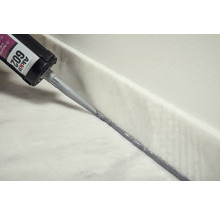 Auftragen von Naturstein Silikon mit einer Kartusche auf eine Marmoroberfläche.