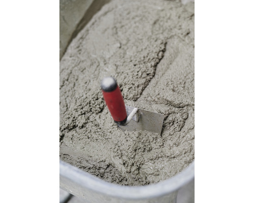 Eimer mit angerührtem Beton und einer Maurerkelle