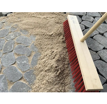 Szene mit Pflastersteinen, Fugensand und Straßenbesen