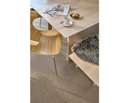 Helles Interieur mit Holztisch, Stuhl, Bank und Teppich