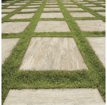 Gartenweg mit quadratischen Steinplatten und Grasfugen