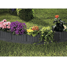 Garten mit Rasenfläche und Beeteinfassung aus Beton mit verschiedenen Blumen