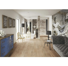 Heller Raum mit Holzboden, Sofa, Stühlen und Kunstwerken