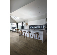 Helle Küche mit Kücheninsel, Barhockern und Holzboden.