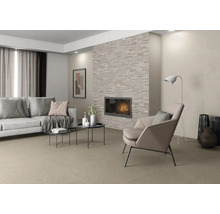 Wohnzimmer mit Sofa, Sessel und Kamin mit Natursteinverkleidung sowie Bodenfliesen