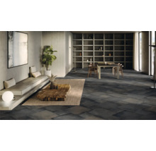 Großzügiger Wohnraum mit dunklem Fliesenboden, Sitzgelegenheit und Esstisch