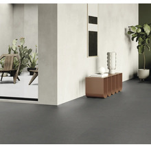 Innenraum mit dunkelgrauem Boden, Tisch, Dekoration und Pflanzen