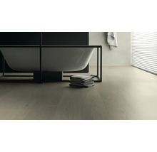 Badezimmer mit freistehender Badewanne, Handtüchern und Holzboden