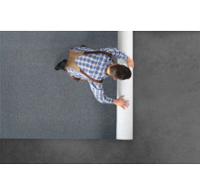 Mann rollt Teppich aus.