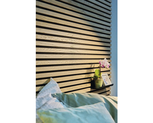 Schlafzimmer mit Wandpaneelen aus Holz und einer Ablage mit Dekoration