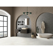 Helles Badezimmer mit Waschtisch, Spiegel, Badewanne und gemauerter Wand