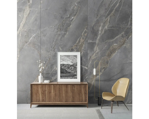 Wohnzimmer mit grauer Marmorwand, Holzkommode, Bild und Sessel