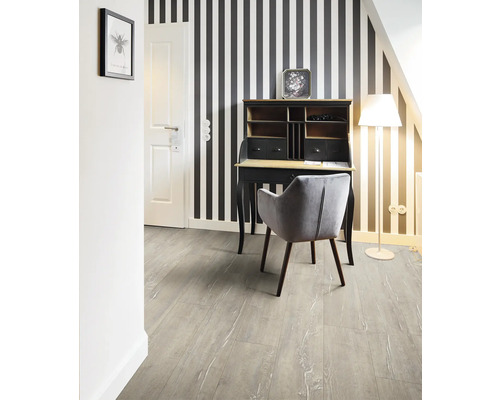 Schreibtisch mit Stuhl in einem Zimmer mit gestreifter Tapete und Laminatboden.
