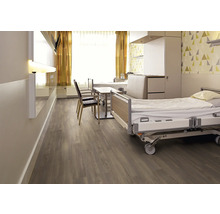 Helles Krankenzimmer mit Betten, Stühlen und Holzfußboden