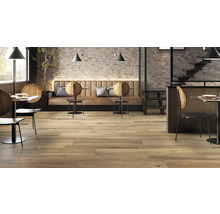 Restaurantinnenraum mit Holzboden, Tischen, Stühlen und Ziegelwand