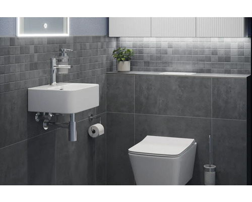 Badezimmer mit Waschbecken, Toilette und grauen Fliesen