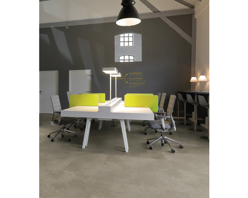 Modernes Büro mit großem weißen Schreibtisch, grünen Sichtschutzwänden, ergonomischen Bürostühlen und Beleuchtung im Industrie-Stil.