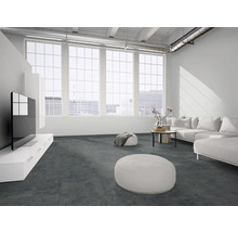 Moderner, heller Wohnraum im Loft-Stil mit dunkelgrauem Boden, weißem Ecksofa, großen Fenstern und sichtbaren Lüftungsrohren.