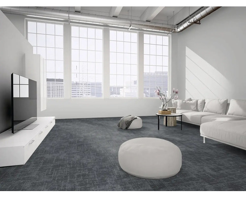 Moderner, heller Wohnraum mit dunkelgrauem gemustertem Teppichboden, großen Fenstern, weißem Sofa und industriellen Deckendetails.