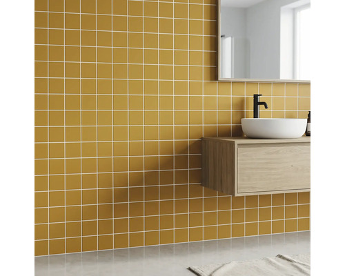 Modernes Badezimmer mit ockerfarbenen quadratischen Wandfliesen, weißem Aufsatzwaschbecken auf hellem Holz-Waschtischunterschrank.