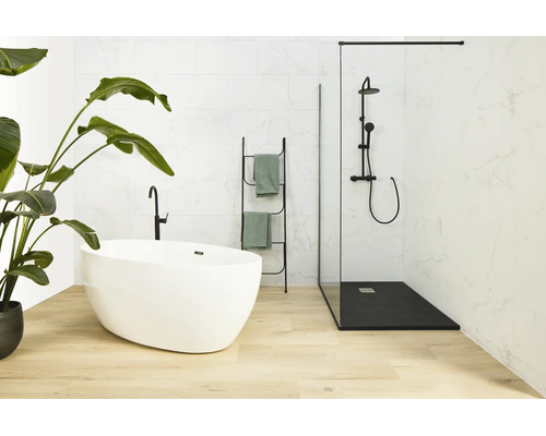 Modernes Badezimmer mit freistehender Badewanne, bodengleicher Duschkabine, Armaturen und Handtuchleiter in hellem Ambiente.