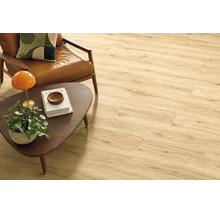 Heller Holzoptik Laminatboden in einem Wohnzimmer mit Ledersessel und Holztisch.