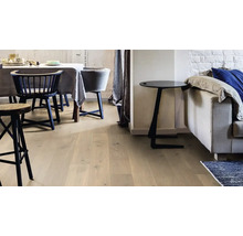 Heller Parkettboden in einem modern eingerichteten Wohnzimmer mit Essbereich und Sofa.