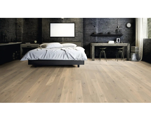 Helles Parkett in einem modernen Schlafzimmer mit Betonwand, Bett und Schreibtisch, vermittelt eine elegante und geräumige Atmosphäre.