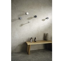 Helle Badgestaltung mit Holzhocker, dekorativer Vase, zwei Flaschen und mehreren Wandhaken