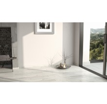 Heller Raum mit Fliesenboden, Kamin und Fensterfront