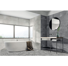 Helles Badezimmer mit Badewanne, Waschtisch, Spiegel und grauen Wand- und Bodenfliesen