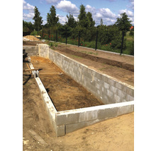 Baugrube mit Betonsteinen im Gartenbau