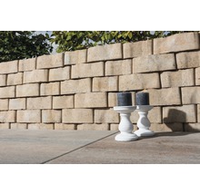 Gartenmauer aus Betonsteinen mit zwei Kerzenleuchtern