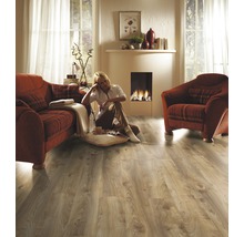 Wohnzimmer mit Laminatboden, Sofa, Sessel und Kamin