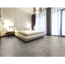 Schlafzimmer mit Bett, Nachttisch und Bodenbelag in Steinoptik