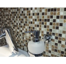 Badezimmer mit Mosaikfliesen, Wasserhahn und Seifenspender