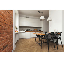 Helle Küche mit Essbereich, Holzboden im Fischgrätmuster und Backsteinwand