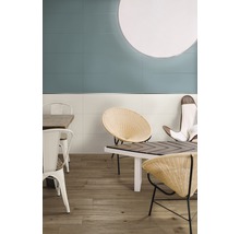 Café-Szene mit blauen und weißen Wandfliesen, Holzboden und Rattan-Stühlen