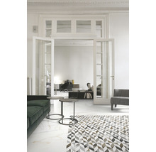 Heller Wohnraum mit Sitzmöbeln, Beistelltischen und Bodenfliesen in Marmoroptik