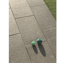 Verlegte Terrassenplatten mit zwei Spielzeugbällen