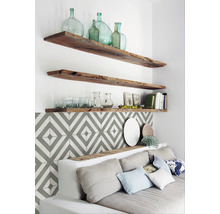 Wohnzimmer mit Holzböden, dekorativen Glasflaschen und Couch mit Kissen