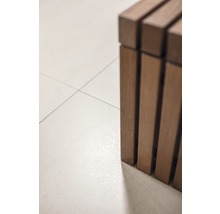 Detailansicht einer Holzbank auf Fliesenboden.