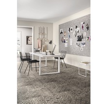 Heller Raum mit Arbeitstisch, Stühlen und Bodenfliesen mit Muster