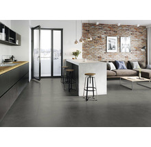 Modernes Wohnzimmer mit Küchenbereich, grauen Fliesen und Backsteinwand.