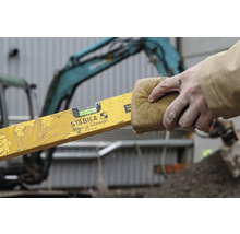 "Eine Person reinigt eine Wasserwaage mit einem Schwamm