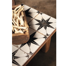 Dekorationstisch mit sternförmigem Fliesenmuster und Holzschale gefüllt mit Deko-Elementen