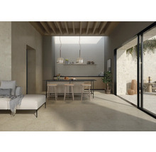 Heller Raum mit Fliesenboden, Kücheninsel, Sitzgelegenheiten und Zugang zum Außenbereich